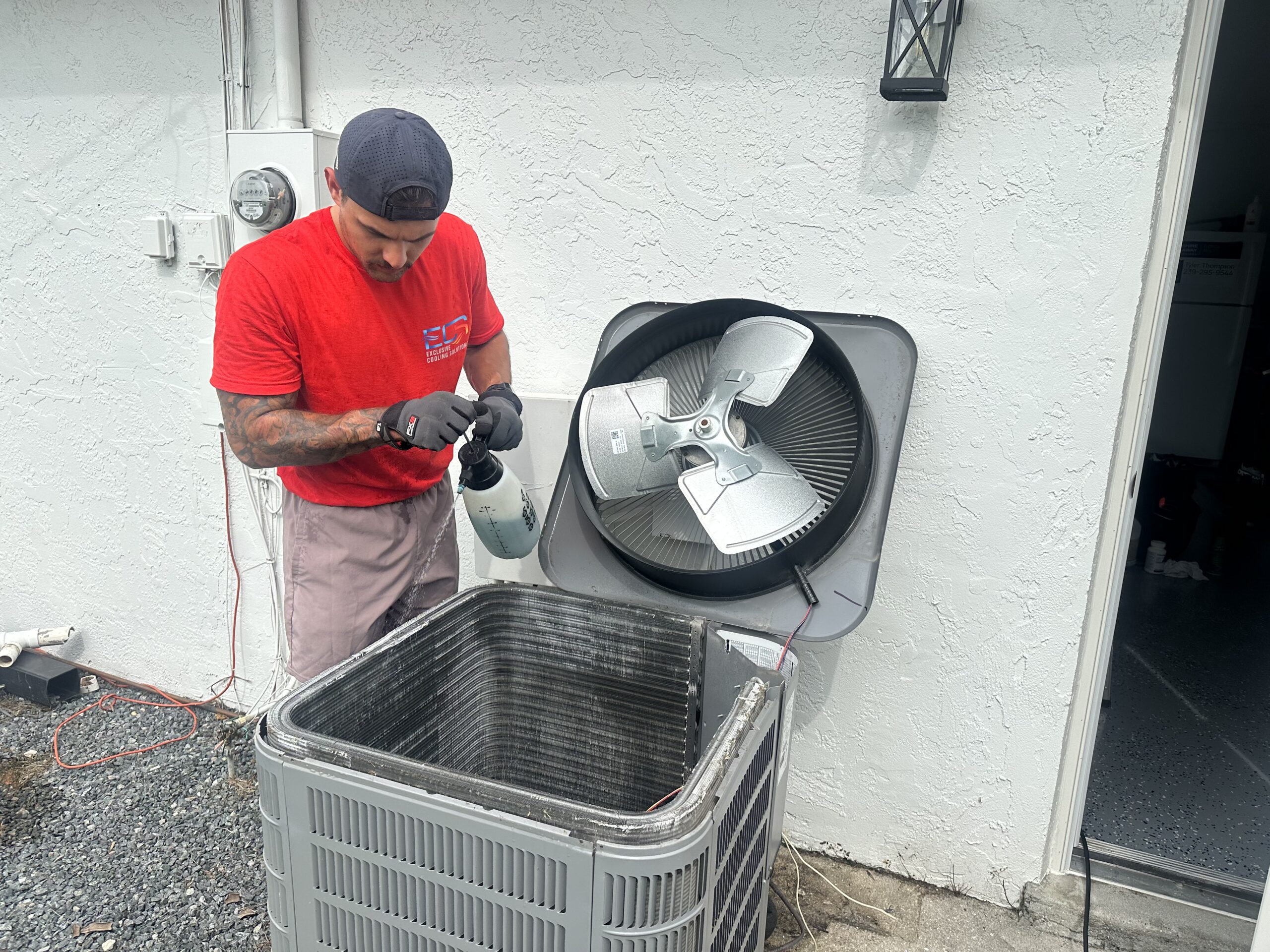 Guiseppi La Mura ECS HVAC technician servicing AC condenser Cape Coral FL